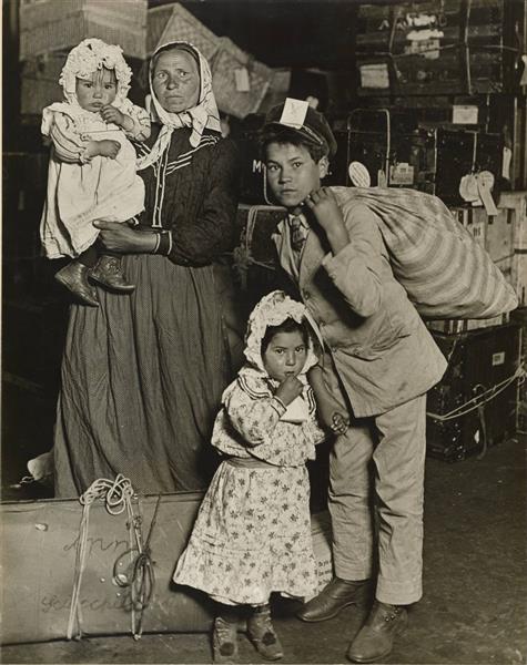 Immigrant Family in the Baggage Room of Ellis Island, 1905 - Lewis Hine